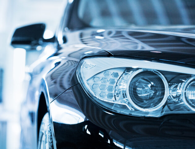 Hamburg, Germany - May 2,  2010 : Close up from the left front of a parking blue BMW 530d. Shallow depth of field with fokus on the headlight. BMW is a German automobile, motorcycle and engine manufacturing company founded in 1916